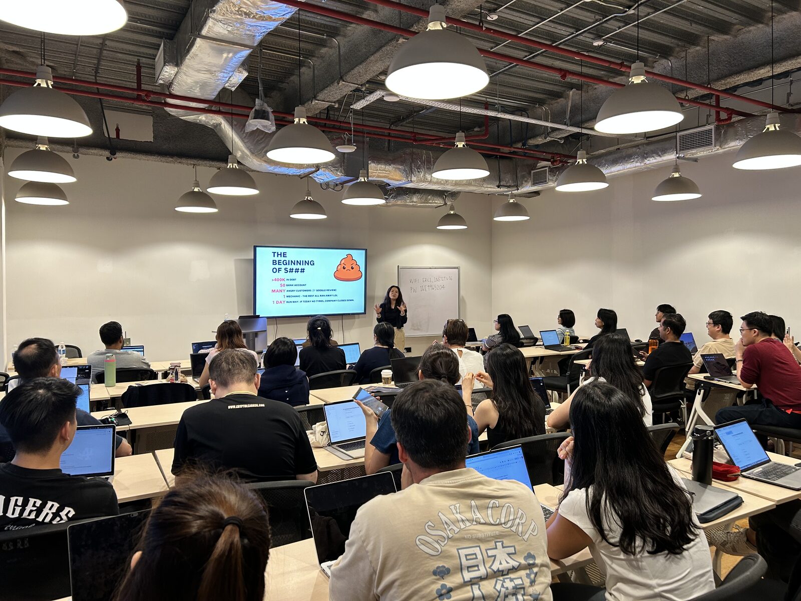 Co-speaker Cordillia presenting a slide on building with Claude to a packed room of attendees