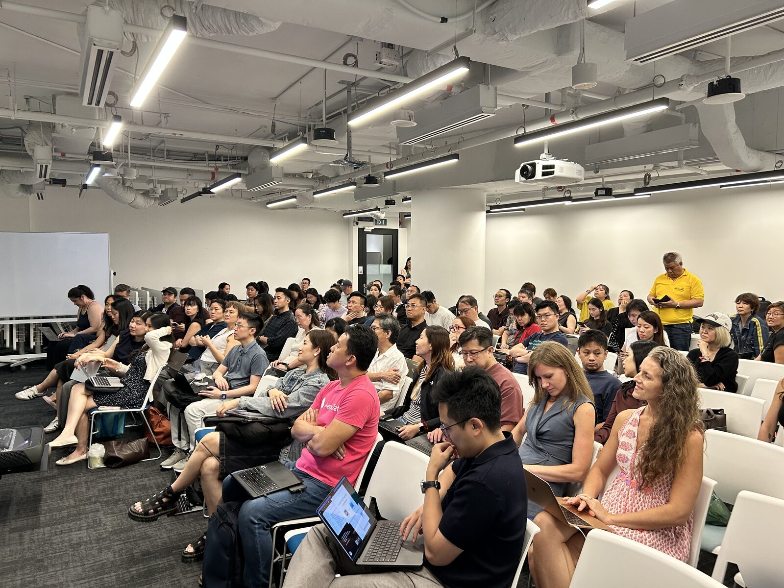 A full room of attendees with laptops open at AI Power Users Meetup 03 at FINEXIS, Singapore
