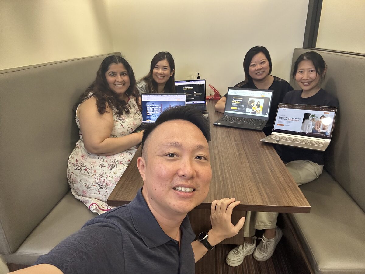 The inaugural 28 March 2026 cohort with Keith, each holding their completed website
